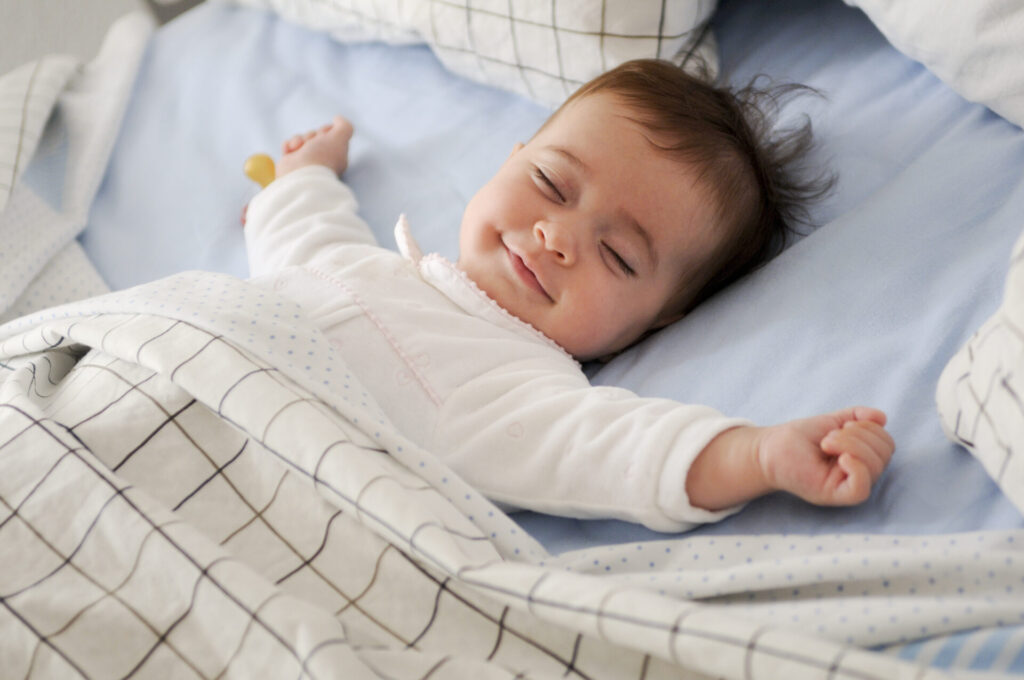 a baby lying in a crib