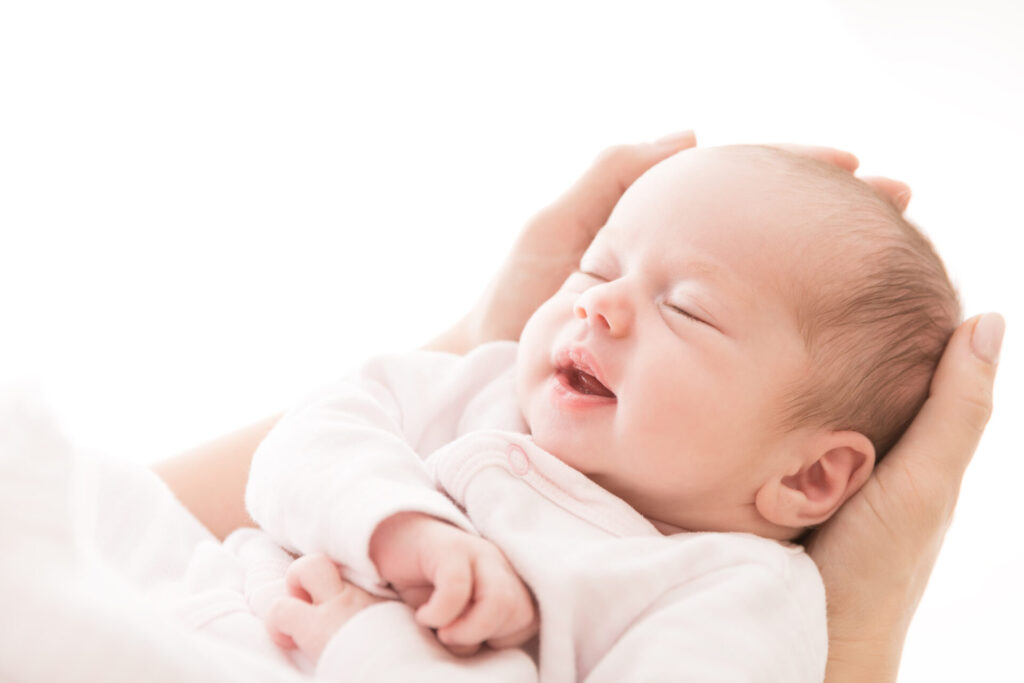 Baby sleeping on mother's hand