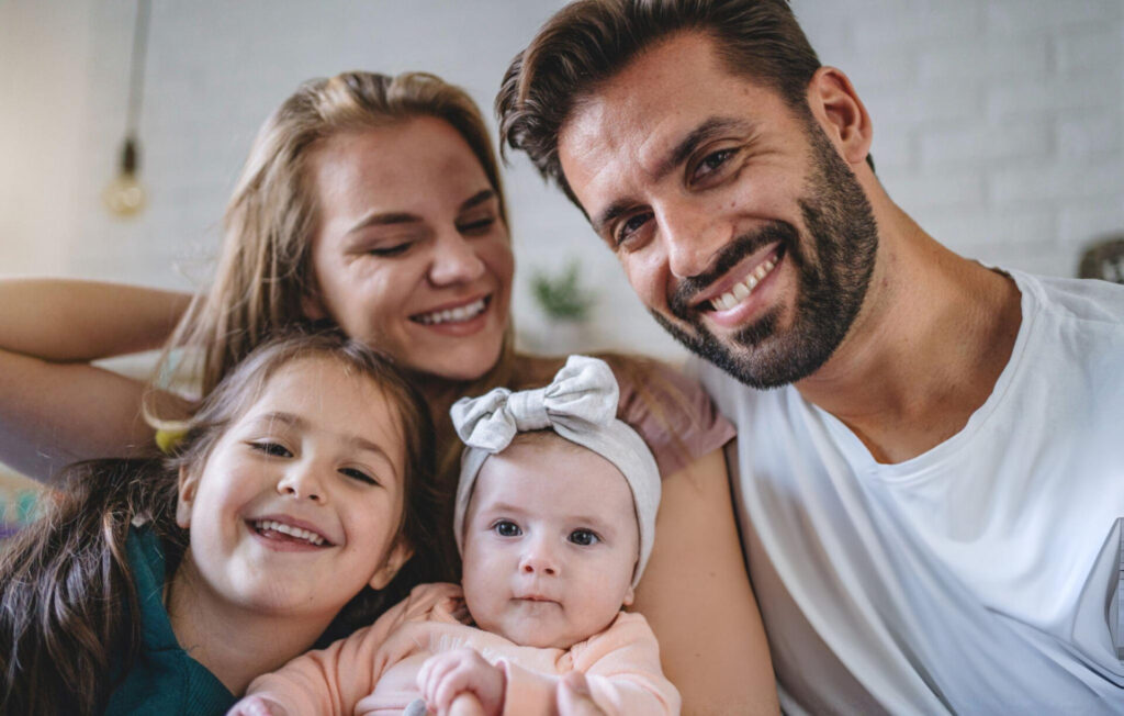a man and woman with two children