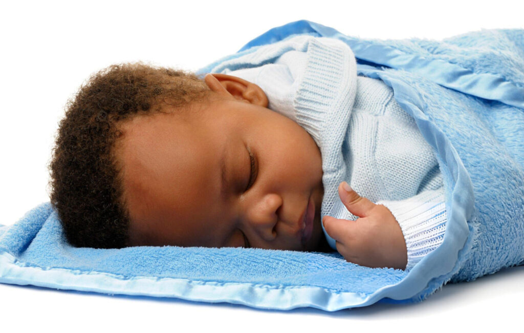 a baby sleeping on a blanket
