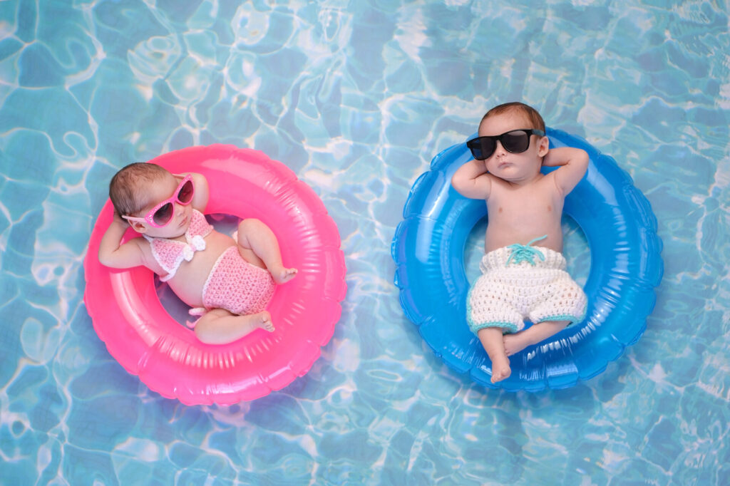 two babies floating on floating rafts in a pool